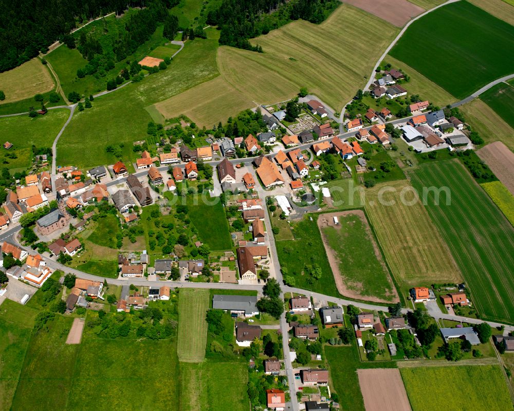 Simmersfeld from above - Agricultural land and field boundaries surround the settlement area of the village in Simmersfeld in the state Baden-Wuerttemberg, Germany