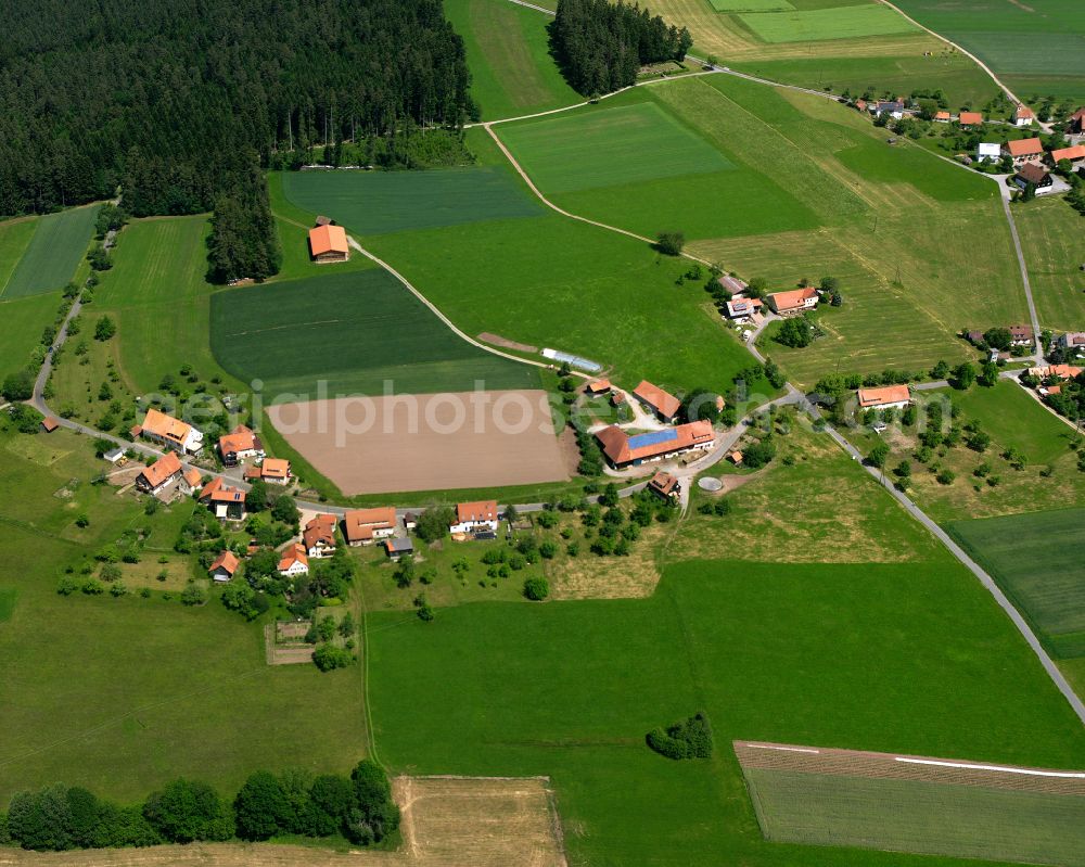 Simmersfeld from the bird's eye view: Agricultural land and field boundaries surround the settlement area of the village in Simmersfeld in the state Baden-Wuerttemberg, Germany