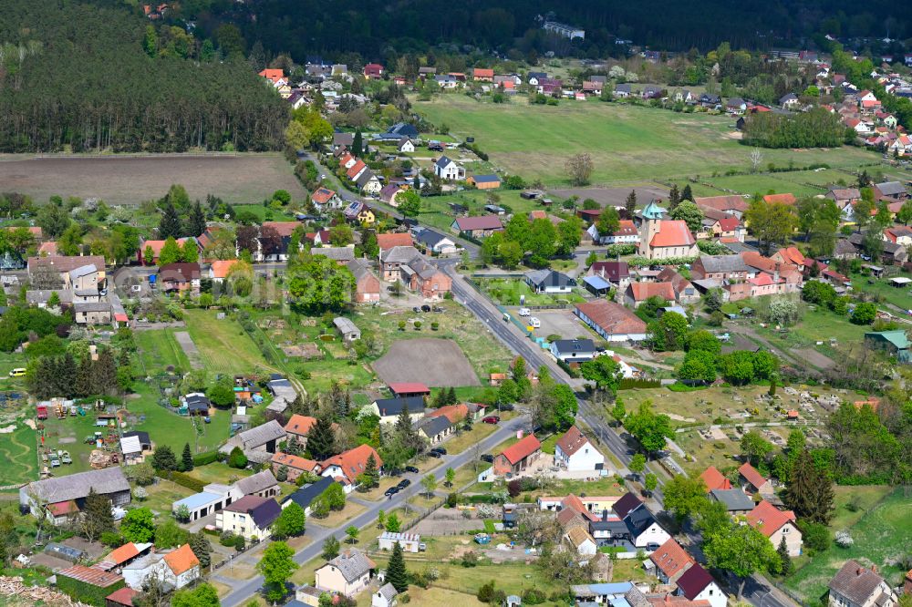 Sommerfeld from the bird's eye view: Agricultural land and field boundaries surround the settlement area of the village in Sommerfeld in the state Brandenburg, Germany