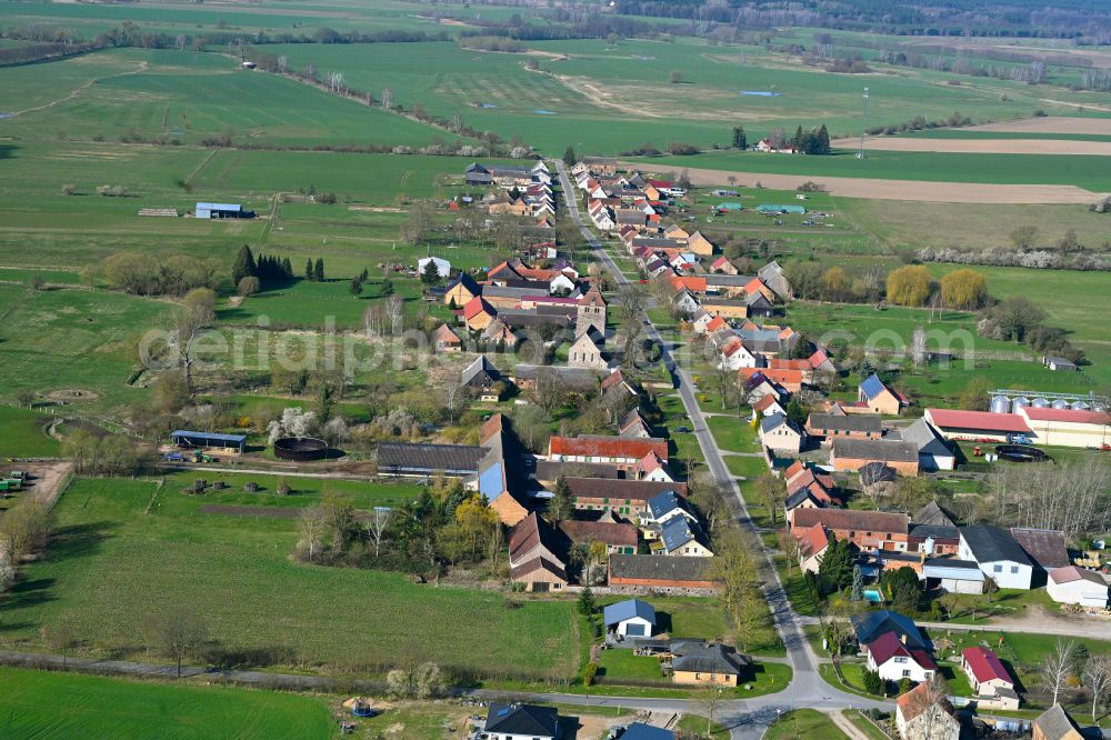 Sonnenberg from the bird's eye view: Agricultural land and field boundaries surround the settlement area of the village in Sonnenberg in the state Brandenburg, Germany