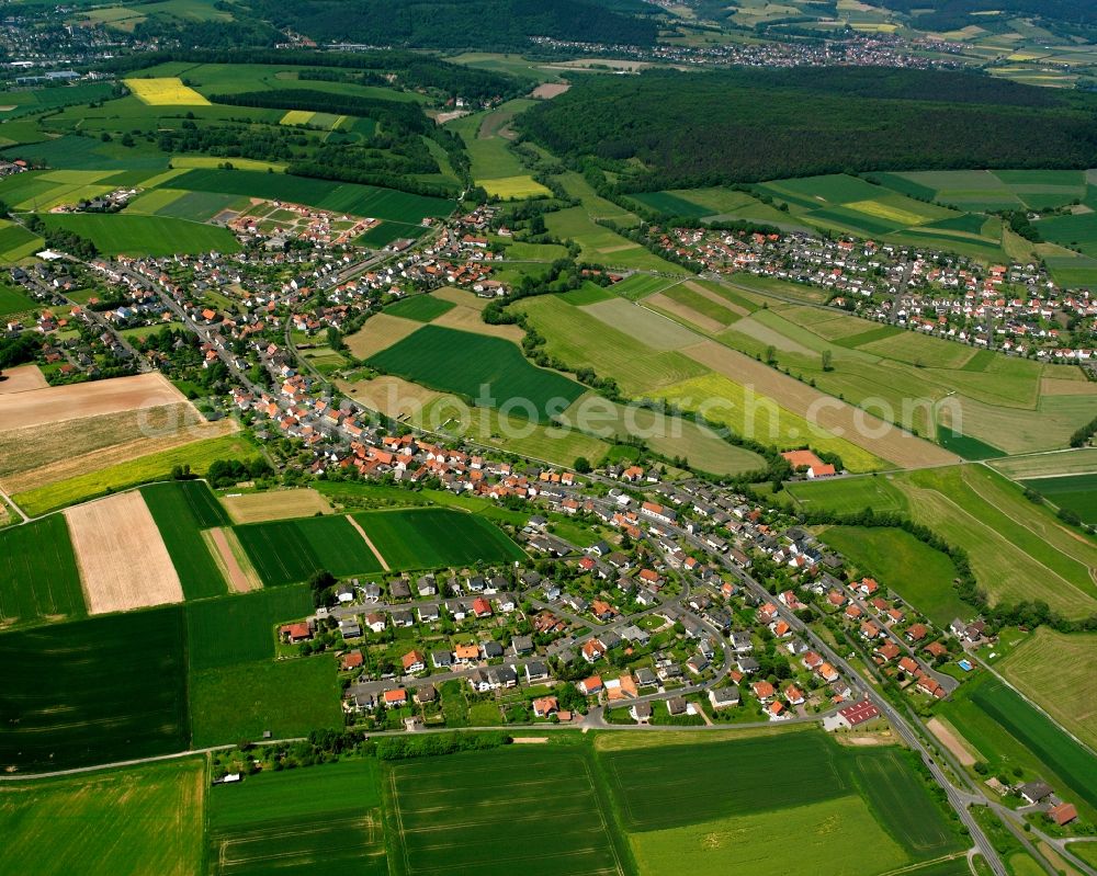 Aerial photograph Sorga - Agricultural land and field boundaries surround the settlement area of the village in Sorga in the state Hesse, Germany