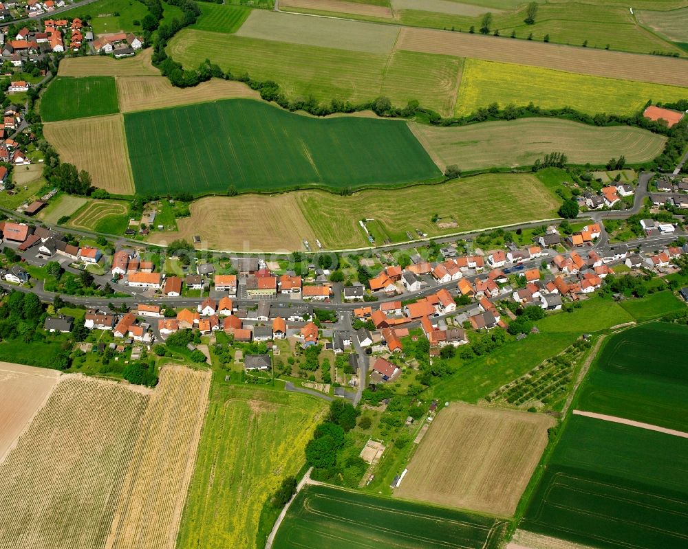 Sorga from the bird's eye view: Agricultural land and field boundaries surround the settlement area of the village in Sorga in the state Hesse, Germany