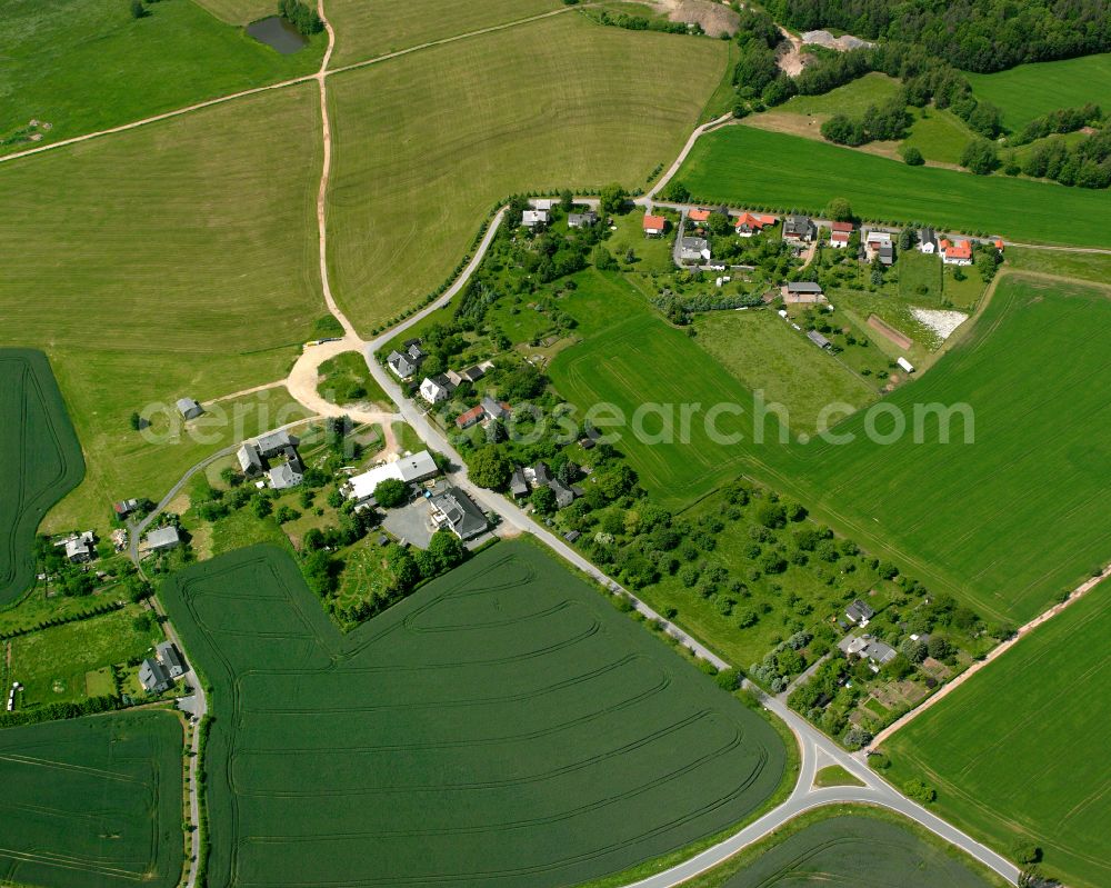 Sorge from above - Agricultural land and field boundaries surround the settlement area of the village in Sorge in the state Thuringia, Germany