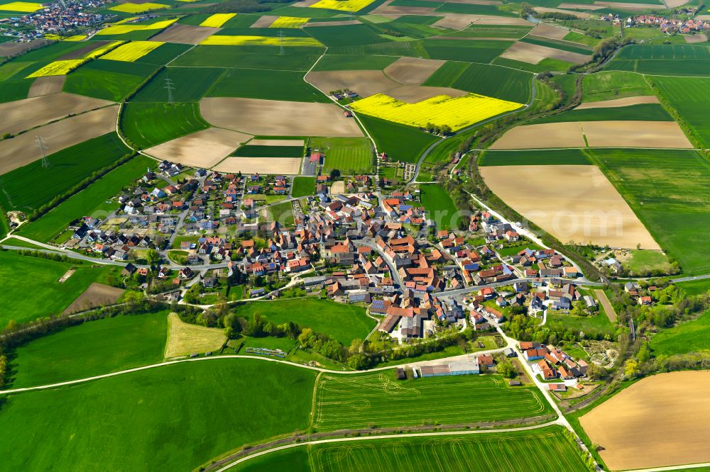 Stadelschwarzach from the bird's eye view: Agricultural land and field boundaries surround the settlement area of the village in Stadelschwarzach in the state Bavaria, Germany