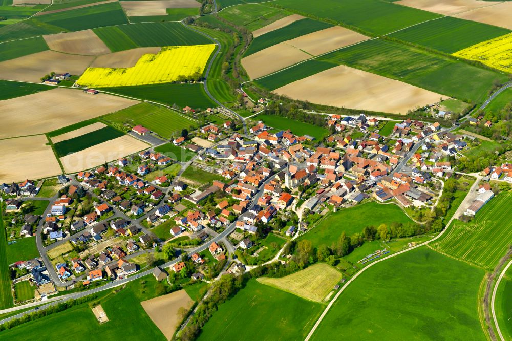 Stadelschwarzach from above - Agricultural land and field boundaries surround the settlement area of the village in Stadelschwarzach in the state Bavaria, Germany