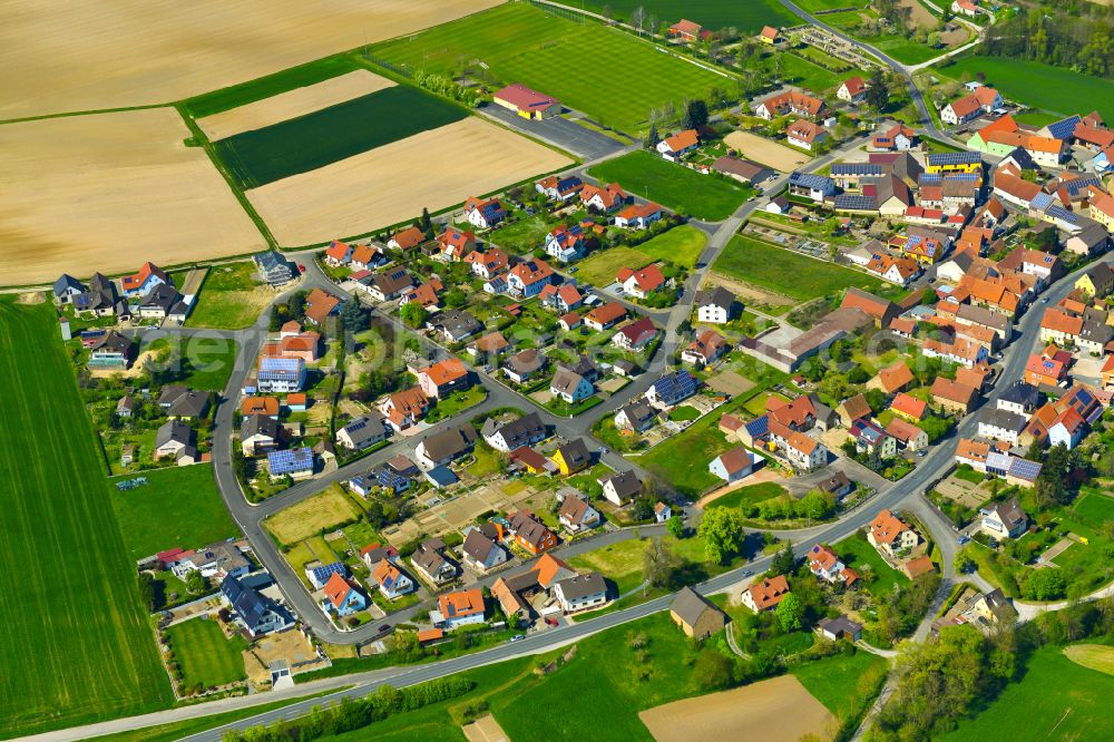 Stadelschwarzach from the bird's eye view: Agricultural land and field boundaries surround the settlement area of the village in Stadelschwarzach in the state Bavaria, Germany