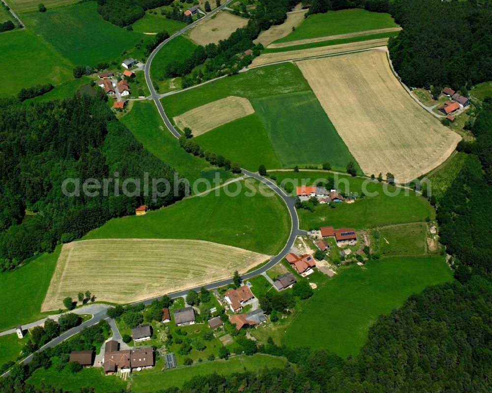 Stallwang from above - Agricultural land and field boundaries surround the settlement area of the village in Stallwang in the state Bavaria, Germany