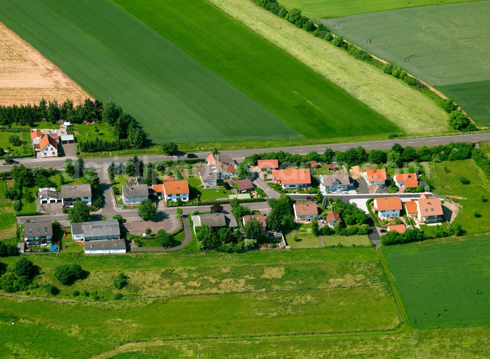 Standenbühl from above - Agricultural land and field boundaries surround the settlement area of the village in Standenbühl in the state Rhineland-Palatinate, Germany