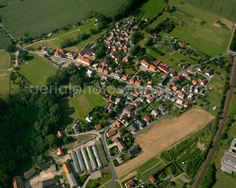 Stauchitz from above - Agricultural land and field boundaries surround the settlement area of the village in Stauchitz in the state Saxony, Germany