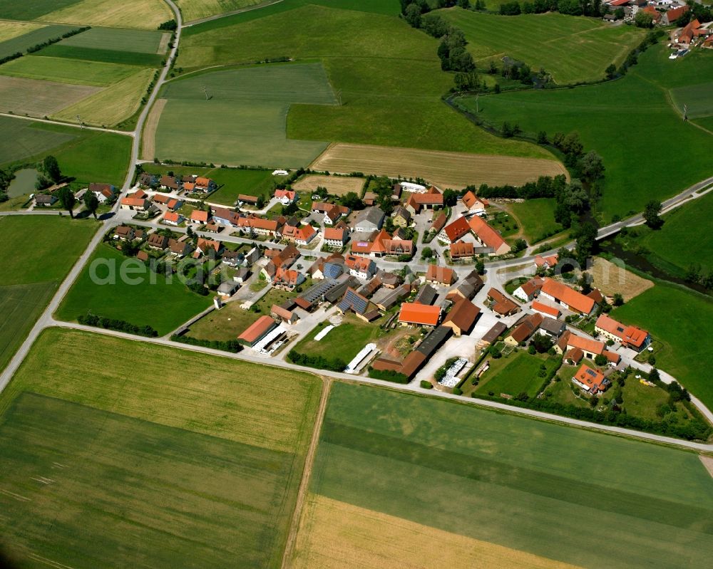 Aerial photograph Stegbruck - Agricultural land and field boundaries surround the settlement area of the village in Stegbruck in the state Bavaria, Germany