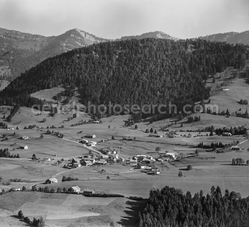 Steibis from above - Agricultural land and field boundaries surround the settlement area of the village in Steibis Allgaeu in the state Bavaria, Germany