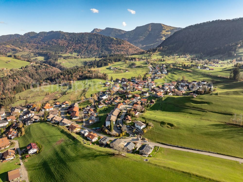 Steibis from above - Agricultural land and field boundaries surround the settlement area of the village in Steibis Allgaeu in the state Bavaria, Germany