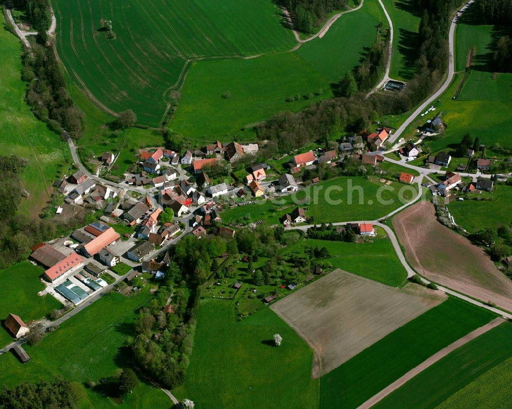 Steinbach from above - Agricultural land and field boundaries surround the settlement area of the village in Steinbach in the state Bavaria, Germany