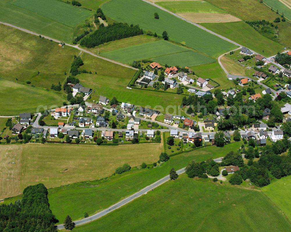 Steinbach from above - Agricultural land and field boundaries surround the settlement area of the village in Steinbach in the state Bavaria, Germany