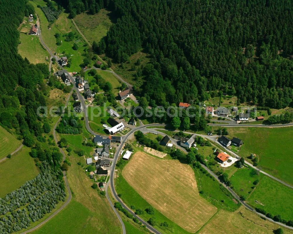 Steinbach from the bird's eye view: Agricultural land and field boundaries surround the settlement area of the village in Steinbach in the state North Rhine-Westphalia, Germany