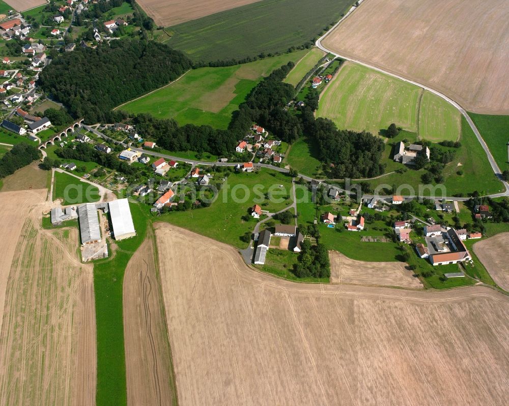 Steinbach from the bird's eye view: Agricultural land and field boundaries surround the settlement area of the village in Steinbach in the state Saxony, Germany