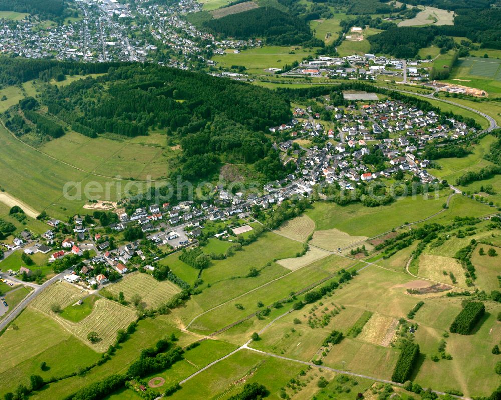 Steinbrücken from above - Agricultural land and field boundaries surround the settlement area of the village in Steinbrücken in the state Hesse, Germany