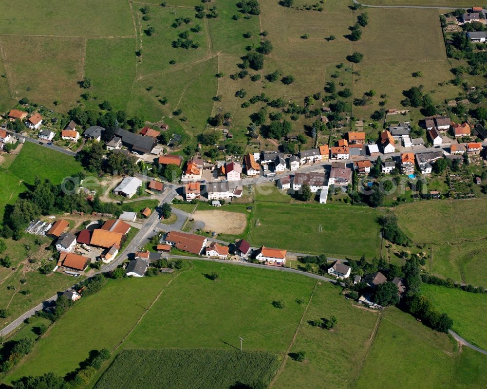 Aerial image Steinbuch - Agricultural land and field boundaries surround the settlement area of the village in Steinbuch in the state Hesse, Germany