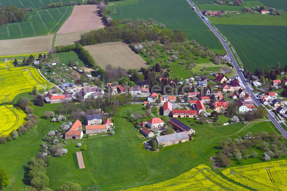 Steindörfel from above - Agricultural land and field boundaries surround the settlement area of the village on B6 in Steindoerfel in the state Saxony, Germany