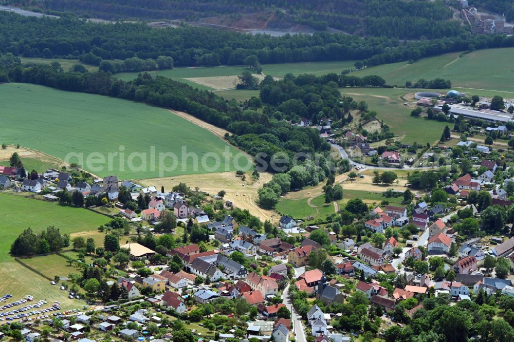 Steinsdorf from above - Agricultural land and field boundaries surround the settlement area of the village in Steinsdorf in the state Thuringia, Germany