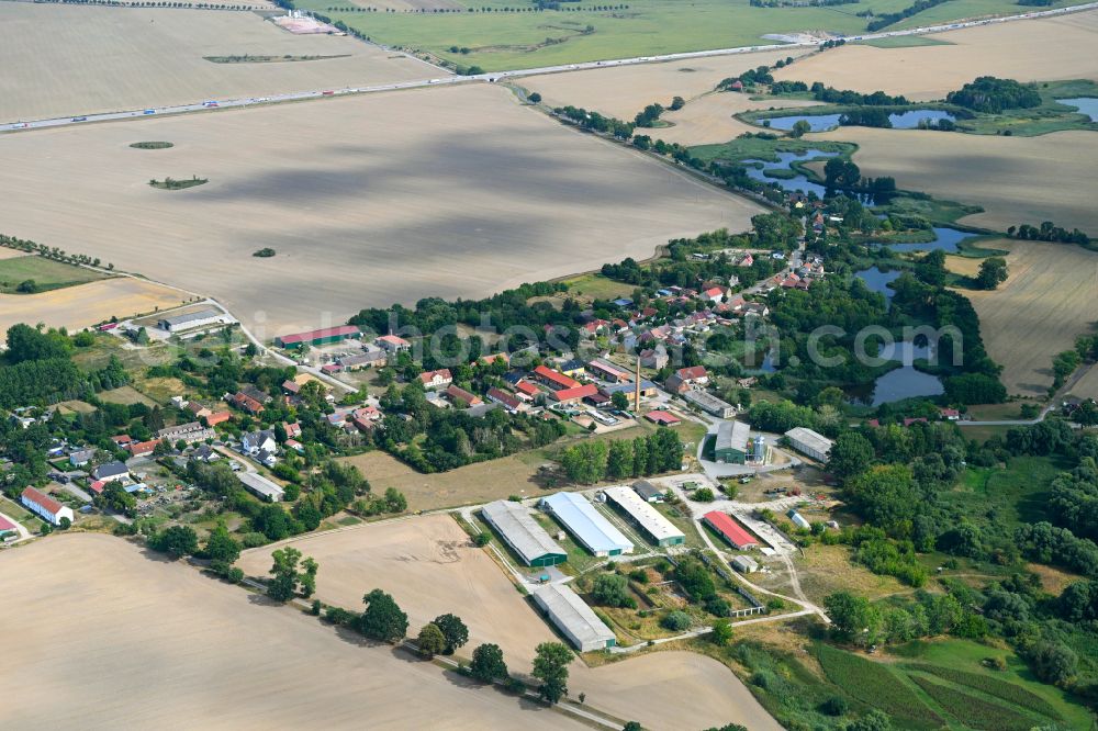 Stöffin from the bird's eye view: Agricultural land and field boundaries surround the settlement area of the village in Stoeffin in the state Brandenburg, Germany