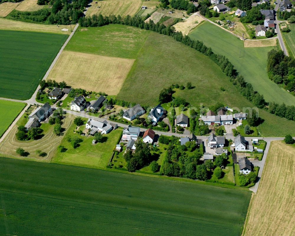 St.Georgenhausen from the bird's eye view: Agricultural land and field boundaries surround the settlement area of the village in St.Georgenhausen in the state Rhineland-Palatinate, Germany