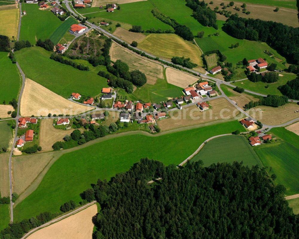 Stippich from above - Agricultural land and field boundaries surround the settlement area of the village in Stippich in the state Bavaria, Germany