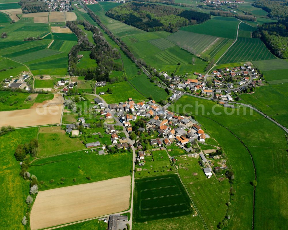 Stockhausen from the bird's eye view: Agricultural land and field boundaries surround the settlement area of the village in Stockhausen in the state Hesse, Germany