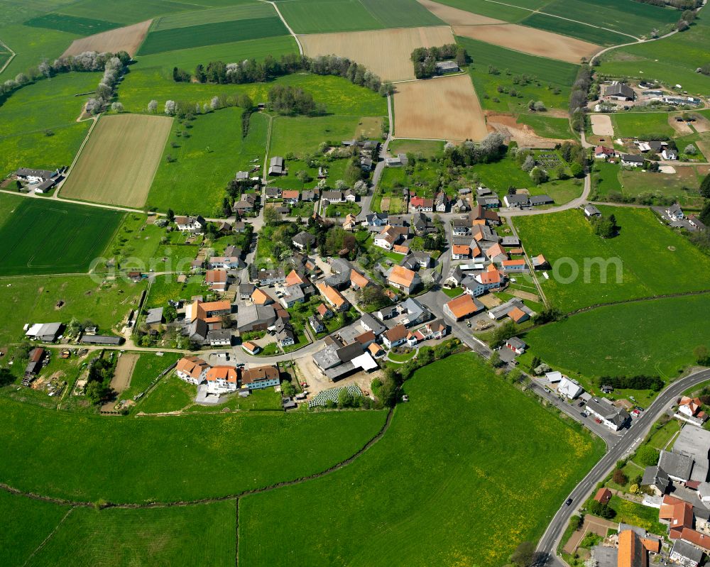 Aerial photograph Stockhausen - Agricultural land and field boundaries surround the settlement area of the village in Stockhausen in the state Hesse, Germany