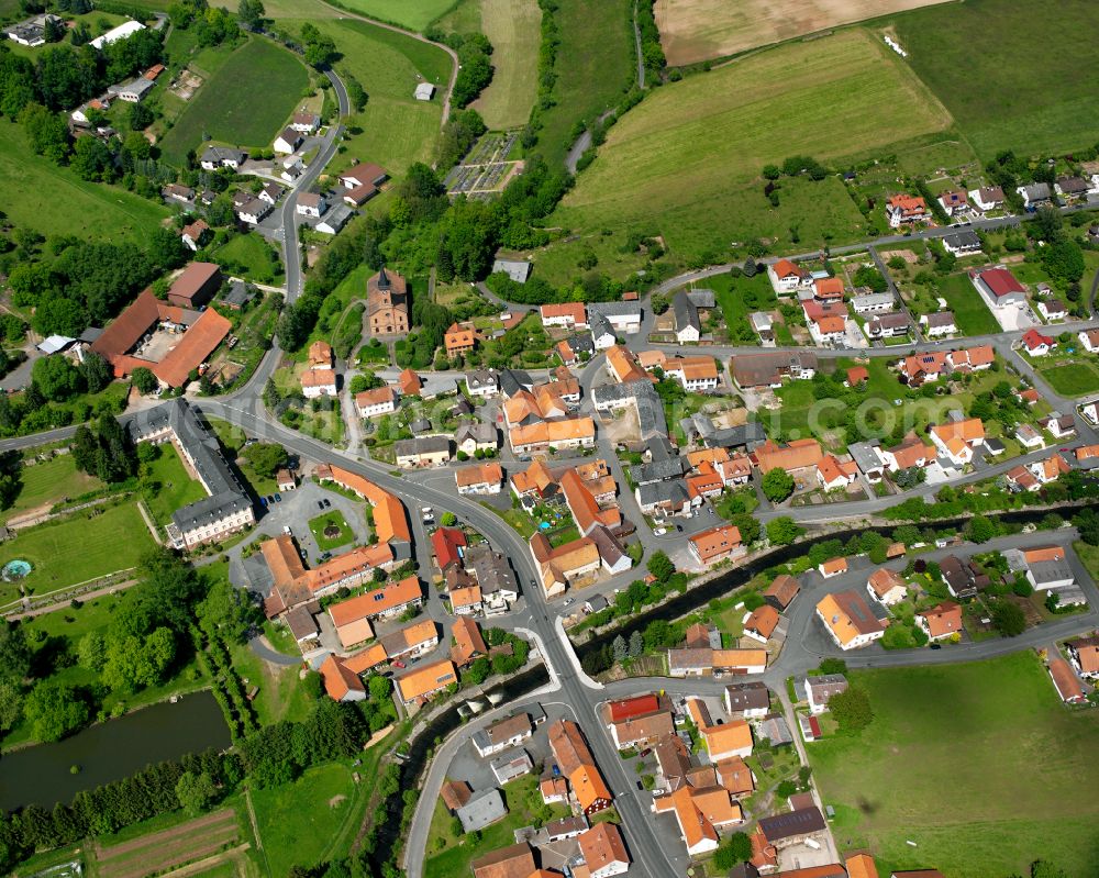 Aerial photograph Stockhausen - Agricultural land and field boundaries surround the settlement area of the village in Stockhausen in the state Hesse, Germany