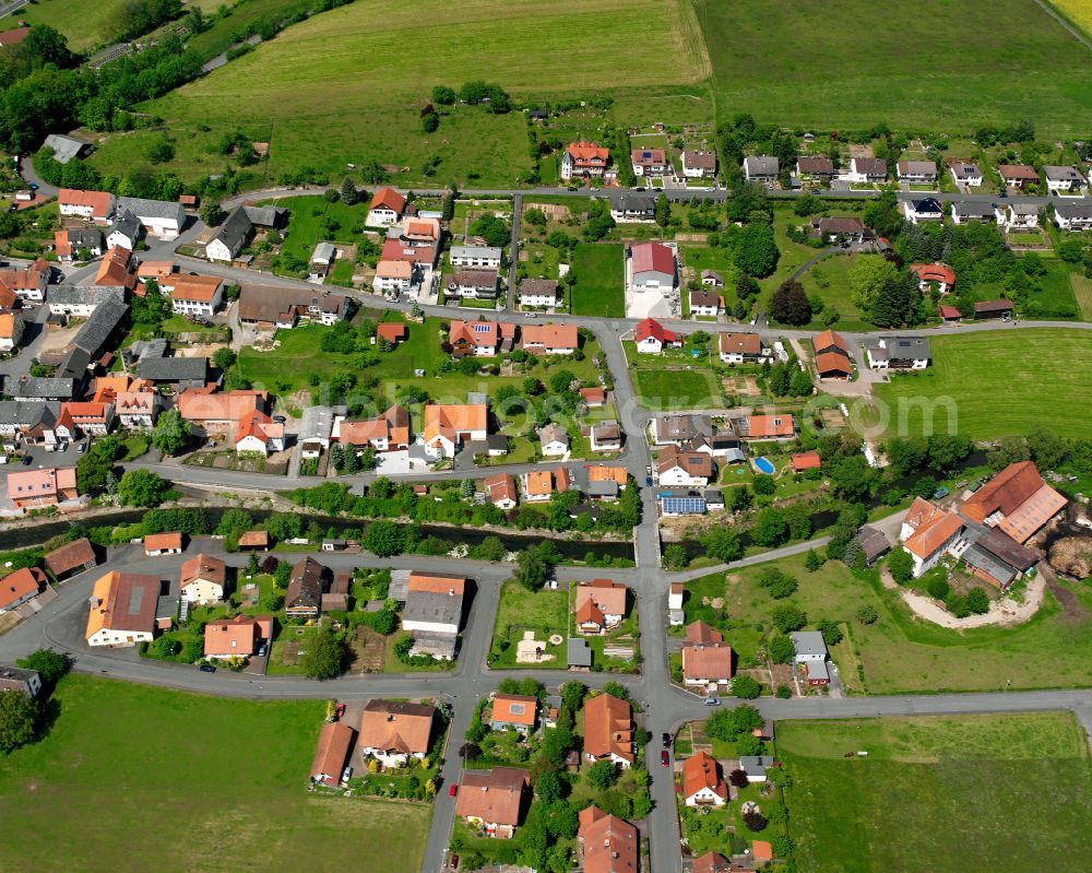 Stockhausen from the bird's eye view: Agricultural land and field boundaries surround the settlement area of the village in Stockhausen in the state Hesse, Germany