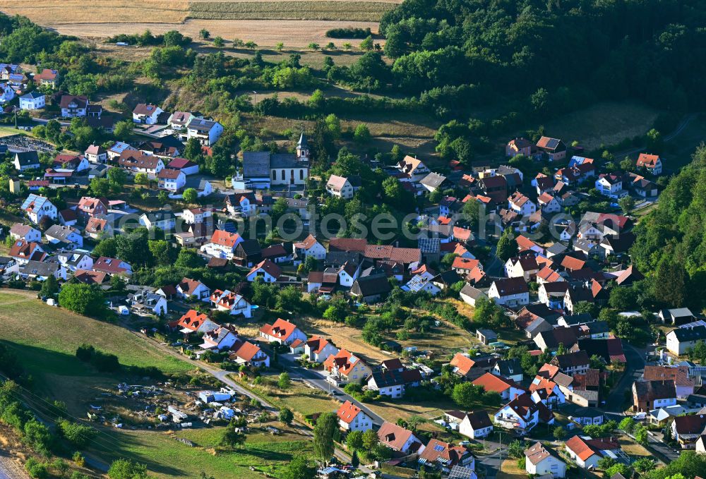 Stralsbach from above - Agricultural land and field boundaries surround the settlement area of the village in Stralsbach in the state Bavaria, Germany