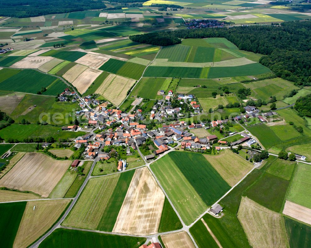 Strebendorf from the bird's eye view: Agricultural land and field boundaries surround the settlement area of the village in Strebendorf in the state Hesse, Germany