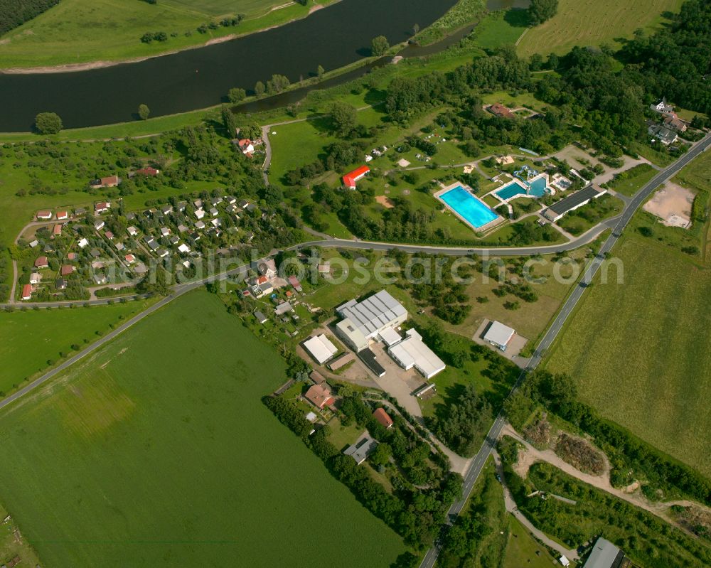 Strehla from the bird's eye view: Agricultural land and field boundaries surround the settlement area of the village in Strehla in the state Saxony, Germany