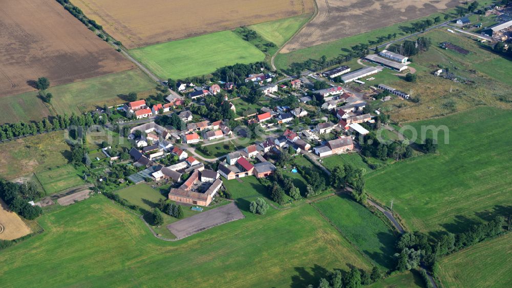 Strinum from above - Agricultural land and field boundaries surround the settlement area of the village in Strinum in the state Saxony-Anhalt, Germany