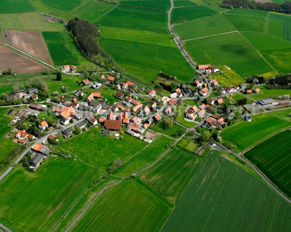 Stärklos from the bird's eye view: Agricultural land and field boundaries surround the settlement area of the village in Stärklos in the state Hesse, Germany