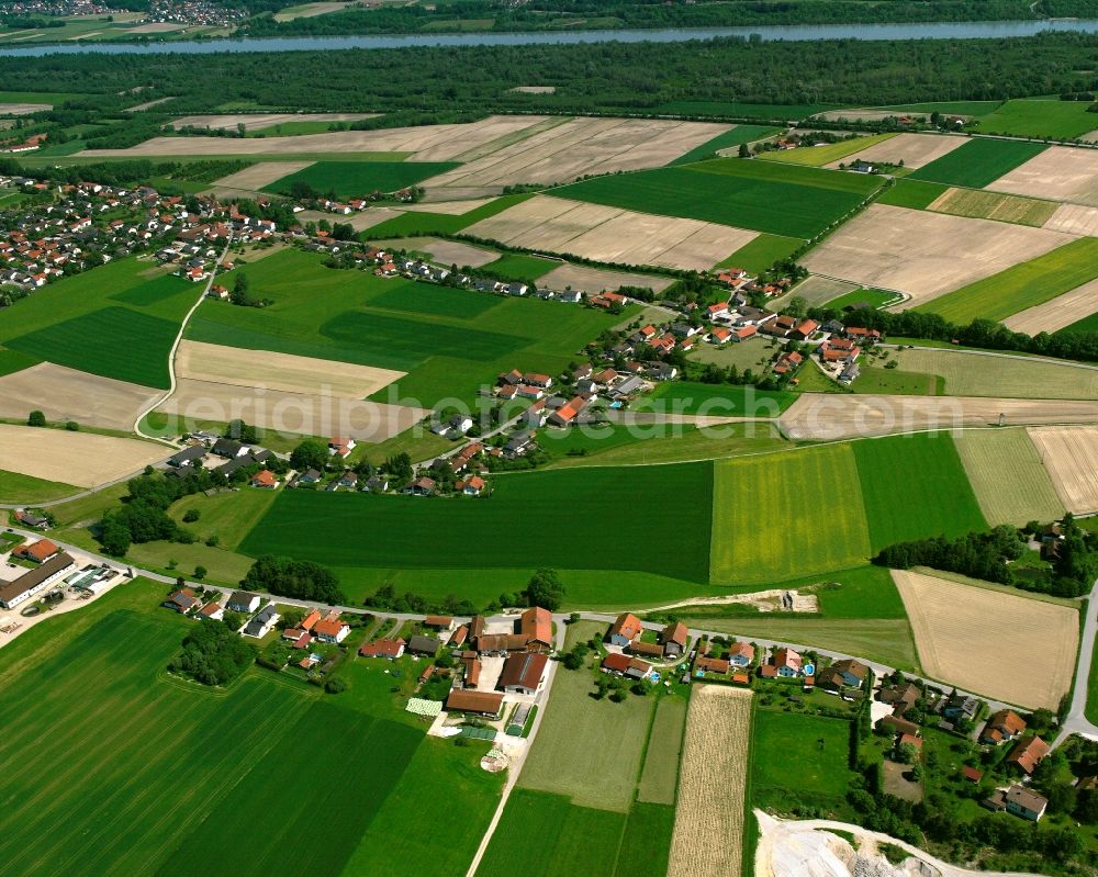 Strohham from above - Agricultural land and field boundaries surround the settlement area of the village in Strohham in the state Bavaria, Germany