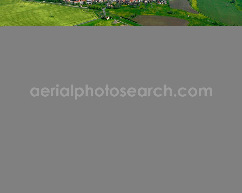 Struth from the bird's eye view: Agricultural land and field boundaries surround the settlement area of the village in Struth in the state Thuringia, Germany