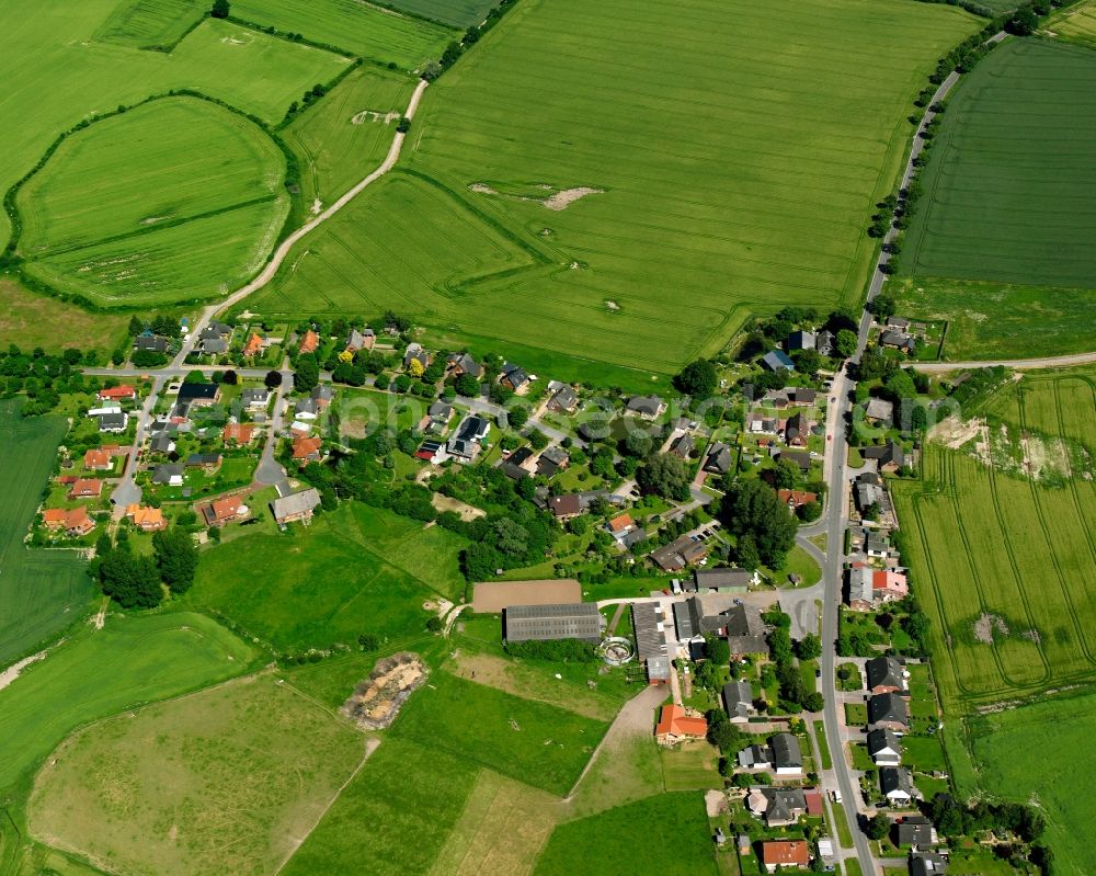 Aerial photograph Stubben - Agricultural land and field boundaries surround the settlement area of the village in Stubben in the state Schleswig-Holstein, Germany