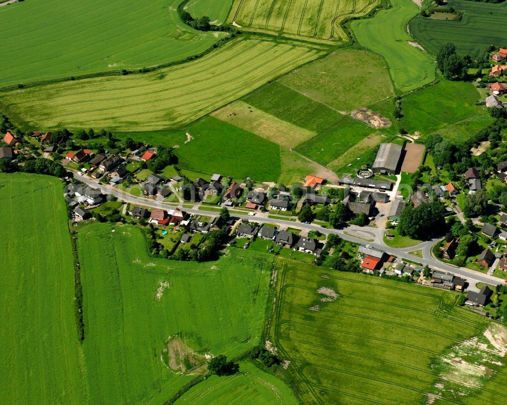 Stubben from above - Agricultural land and field boundaries surround the settlement area of the village in Stubben in the state Schleswig-Holstein, Germany