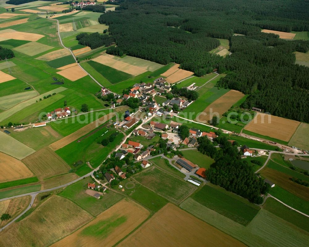 Suddersdorf from above - Agricultural land and field boundaries surround the settlement area of the village in Suddersdorf in the state Bavaria, Germany