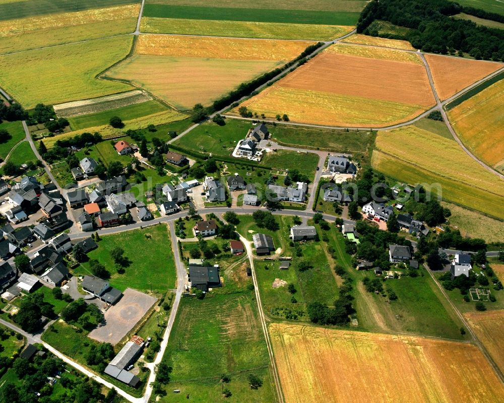 Sulzbach from the bird's eye view: Agricultural land and field boundaries surround the settlement area of the village in Sulzbach in the state Rhineland-Palatinate, Germany