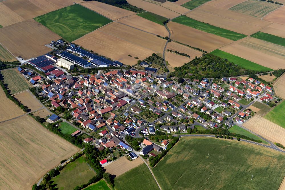 Aerial image Sulzdorf - Agricultural land and field boundaries surround the settlement area of the village in Sulzdorf in the state Bavaria, Germany