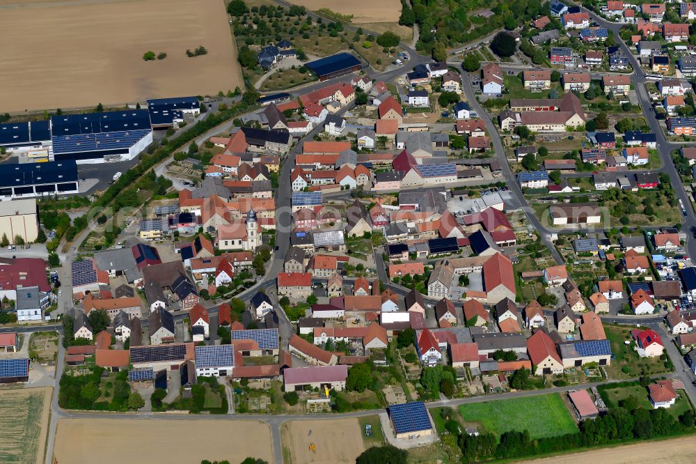 Aerial photograph Sulzdorf - Agricultural land and field boundaries surround the settlement area of the village in Sulzdorf in the state Bavaria, Germany