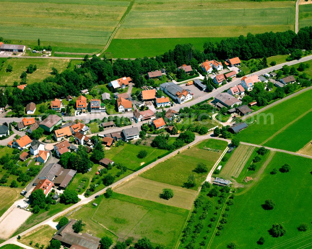 Talheim from the bird's eye view: Agricultural land and field boundaries surround the settlement area of the village in Talheim in the state Baden-Wuerttemberg, Germany