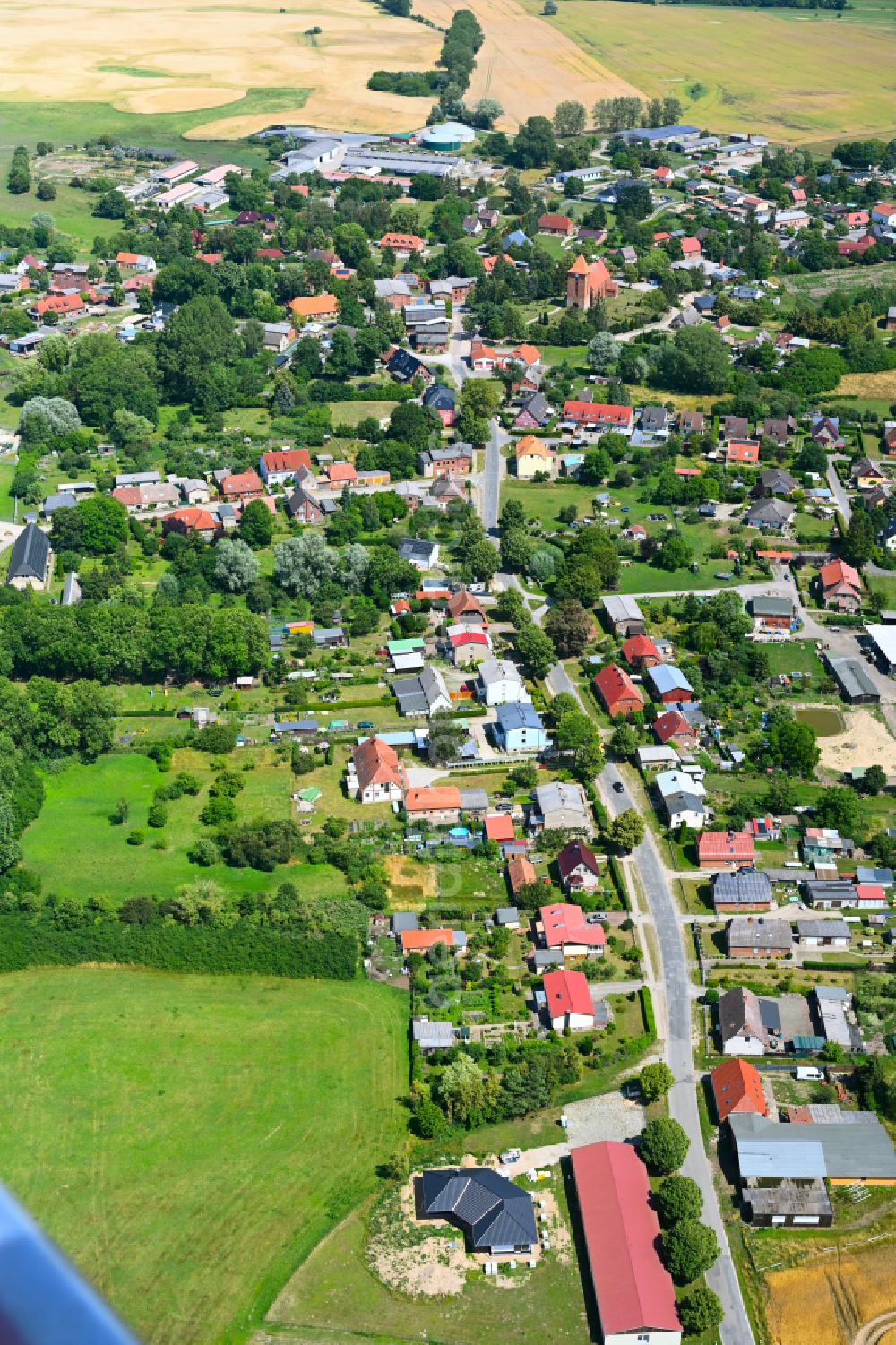 Tarnow from above - Agricultural land and field boundaries surround the settlement area of the village in Tarnow in the state Mecklenburg - Western Pomerania, Germany