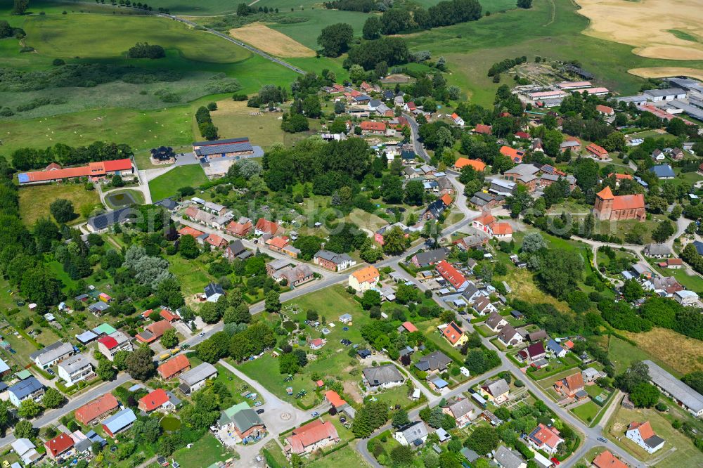 Tarnow from the bird's eye view: Agricultural land and field boundaries surround the settlement area of the village in Tarnow in the state Mecklenburg - Western Pomerania, Germany