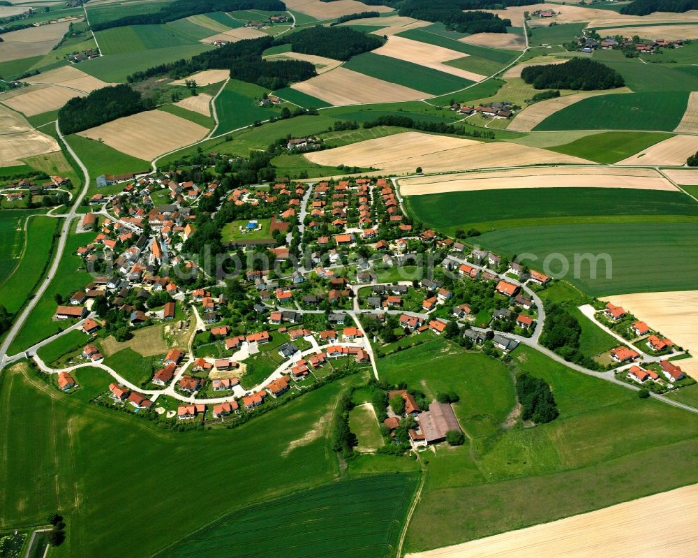 Taufkirchen from above - Agricultural land and field boundaries surround the settlement area of the village in Taufkirchen in the state Bavaria, Germany