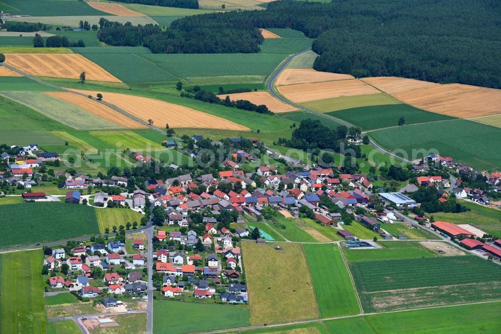 Aerial image Thansüß - Agricultural land and field boundaries surround the settlement area of the village in Thansuess in the state Bavaria, Germany