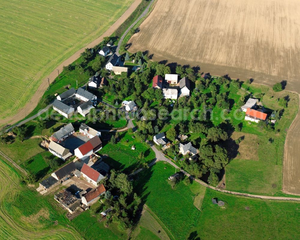 Aerial image Theesdorf - Agricultural land and field boundaries surround the settlement area of the village in Theesdorf in the state Saxony, Germany